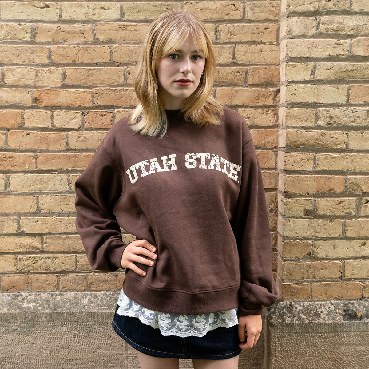 Young woman wearing brown utah state bandana print oversized sweatshirt